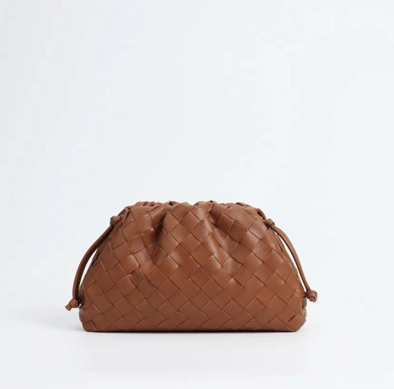 Brown woven handbag on a white background
