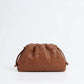 Brown woven handbag on a white background