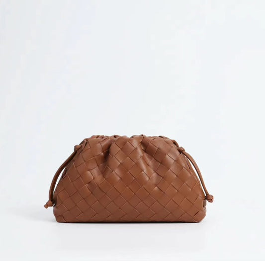 Brown woven handbag on a white background